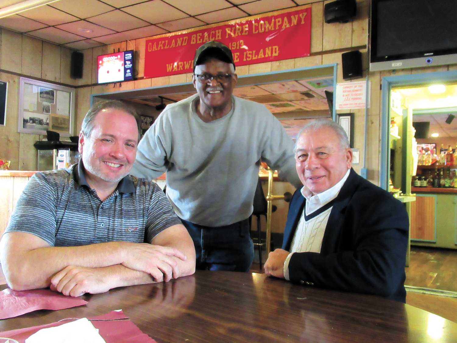 WARM WELCOME: Vin Bellows (middle) welcomes Al Caldarone and is son Al Caldarone Jr. before sitting with them for last Thursday’s fantastic foodfest at the Oakland Beach Firemen’s’ Club in Warwick.